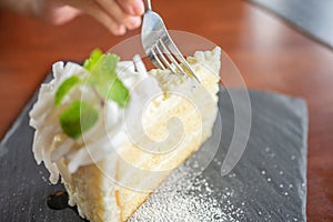 Asian beauty Scooping the cake to eat In Caffe Holiday idea Eating sweets, the cause of obesity, weight gain, poor health