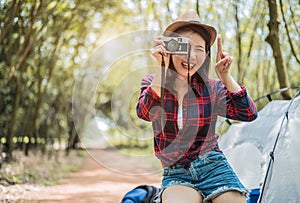 Asian beauty traveler taking photograph by digital cemera while hiking camping. Adventure and leisure activity concept. Happy life