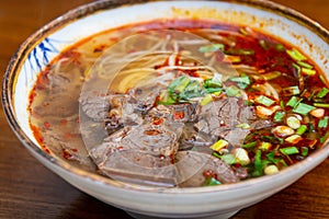 Asian beef slices and noodle soup in a bowl