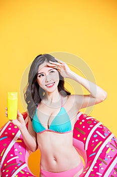 Asian bikini girl take sunscreen