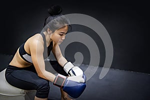 Asian boxer woman posing with boxing gloves