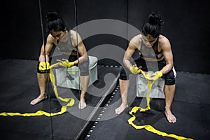 Asian boxer woman wearing yellow strap on wrist