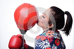 Asian boxing woman kiss punching bag