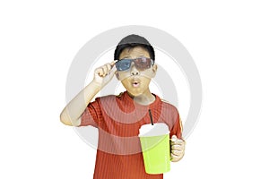 Asian boy with 3D glasses holding plastic cup isolation in clipping path.