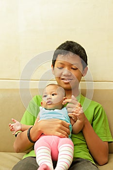Asian boy babysit a baby photo