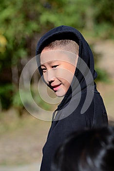 Asian boy in a black hooded sweat shirt