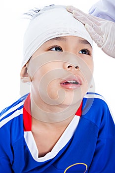 Asian boy in blue sportswear with trauma of the head.