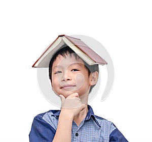 Asian boy with book on head thinking