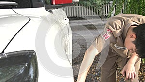 Asian boy in boy scouts uniform car washing at home, Thailand boy scouts helping your family at home.