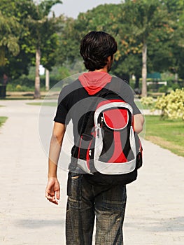 Asian boy carrying backpack