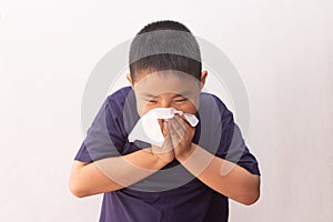 Asian boy cold flu illness tissue blowing runny nose