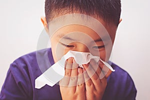 Asian boy cold flu illness tissue blowing runny nose