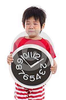 Asian boy crying and holding clock