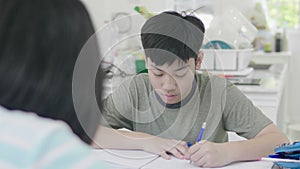 Asian boy doing your homework with tablet computer,