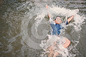 Asian boy drowning in the pool dangerous and need to help