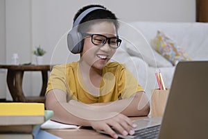 Asian boy enjoy self study with e-learning at home