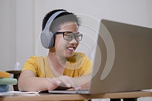 Asian boy enjoy self study with e-learning at home