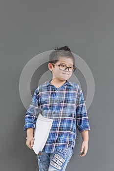 Asian boy feels excited when time to school and his hands hold the book