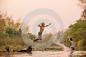 Asian boy and girl playing in the river