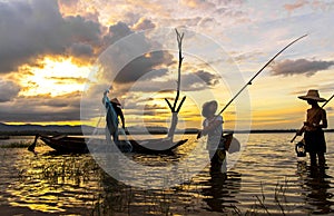 Asian boy and girl playing in the river with fisherman,