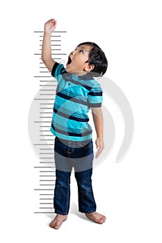 Asian boy growing tall measuring