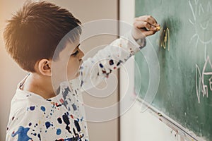 Asian boy happy smile enjoy education at school in classroom writing answer at chalkboards