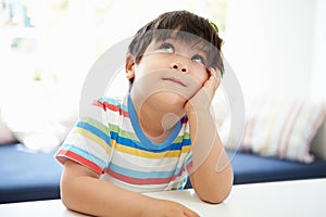 Asian Boy With Head In Hands Thinking