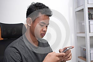 Asian boy with hearing aid device using phone