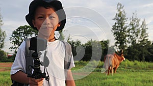 An Asian boy holding an action camera suggests a place to set up a tent