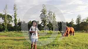 An Asian boy holding an action camera suggests a place to set up a tent