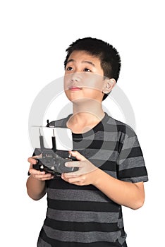 Asian boy holding radio remote control handset for helicopter, drone or plane, isolated on white background, clipping path