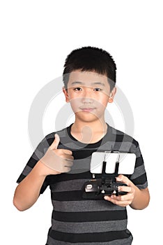 Asian boy holding radio remote control for helicopter, drone or plane and giving thumbs up, isolated on white background,