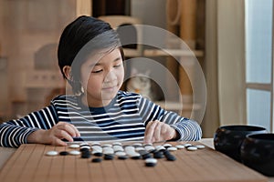 Asian boy learned to play Chinese go game