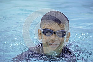 Asian boy learned to swim in the pool