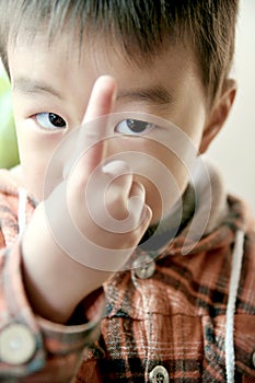 Asian boy look at his finger photo
