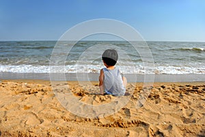 Asian boy looking at the sea