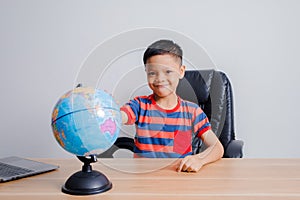 Asian boy looking at world map