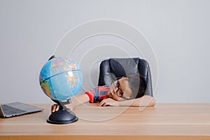 Asian boy looking at world map