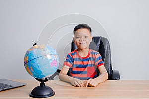 Asian boy looking at world map