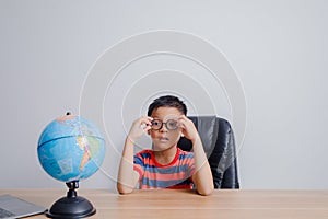 Asian boy looking at world map