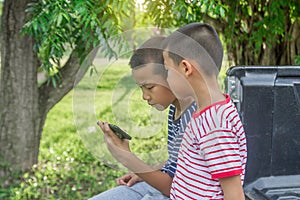 Asian boy play game with smartphone