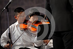Asian boy play the violin