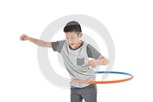 Asian boy playing with the hulahoop on a white