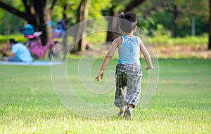 An asian boy playing outdoor activity with excited on something new