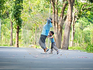An asian boy playing outdoor with his mother