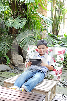 Asian boy playing tablet
