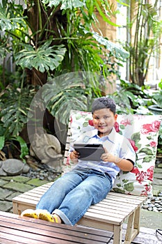 Asian boy playing tablet