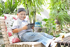 Asian boy playing tablet