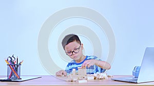 Asian boy playing with a wooden puzzle