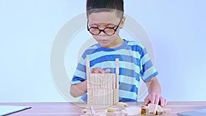 Asian boy playing with a wooden puzzle